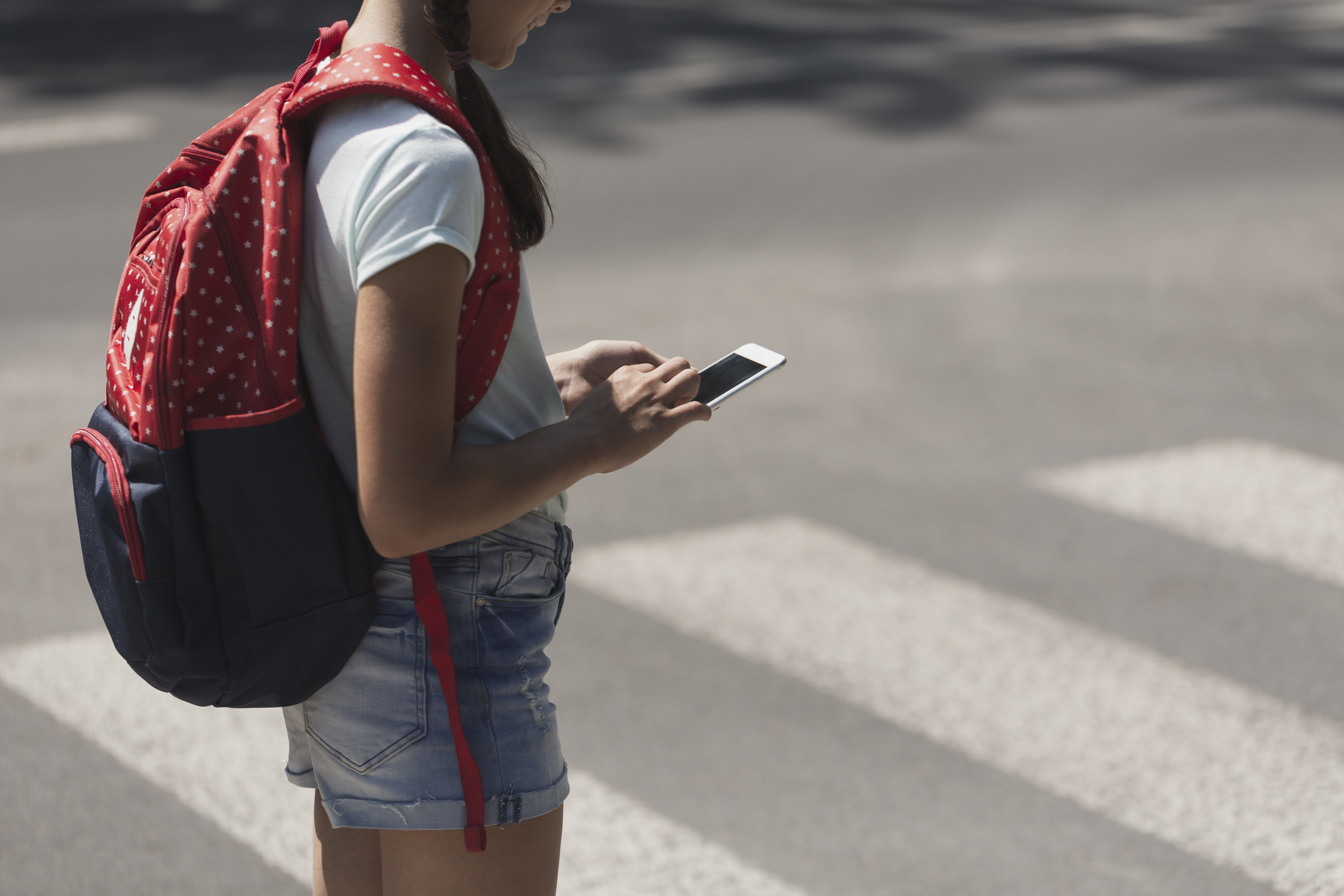 teenage-schoolgirl-with-backpack-using-phone-durin-2023-11-27-04-58-19-utc